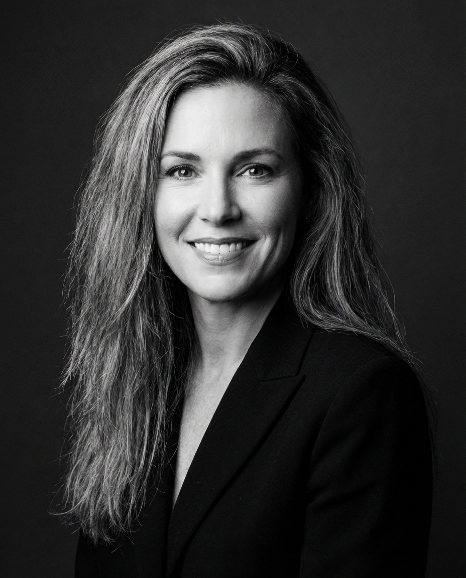 professional black and white portrait photo of a woman with long hair, studio lighting, dark background, corporate headshot style