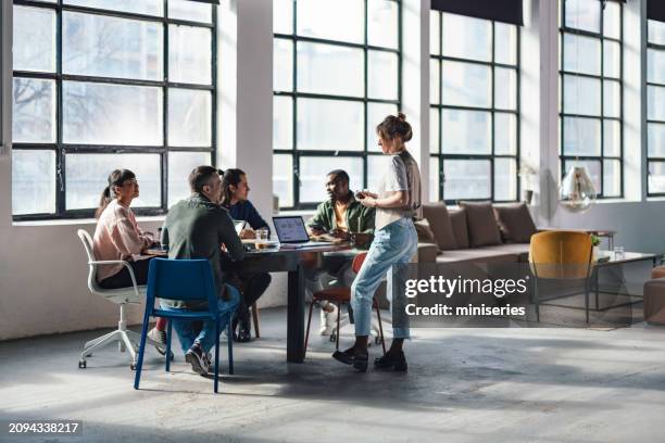 modern young professionals collaborating in a bright modern office with glass walls