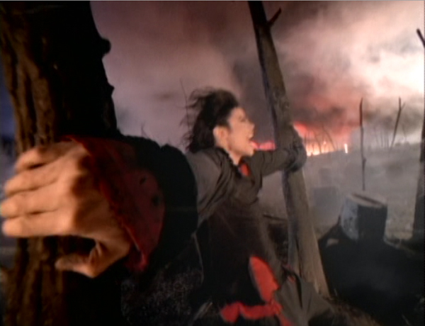 Michael Jackson Earth Song video people kneeling holding dirt wind blowing