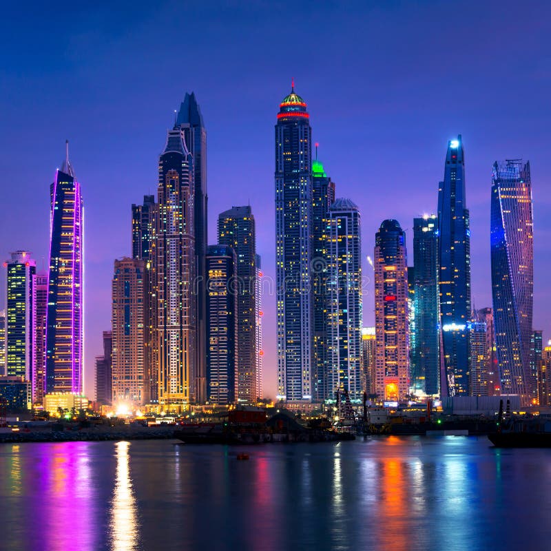 Night view of Dubai Marina skyline, vibrant lights, water reflection, high quality photography