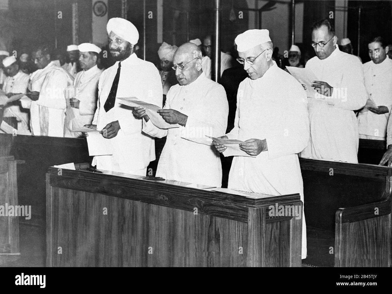 Old black and white photo of the Constituent Assembly of India meeting in 1946, historical archive style