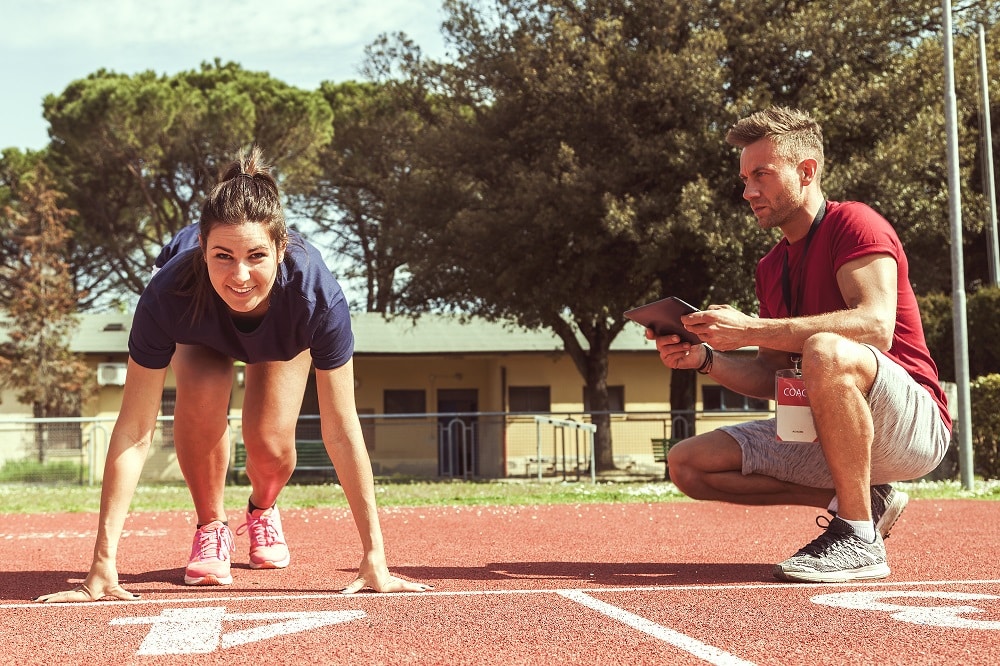 Coach showing techniques on running track