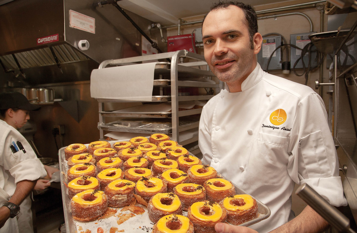 Dominique Ansel holding a tray of pastries bakery New York