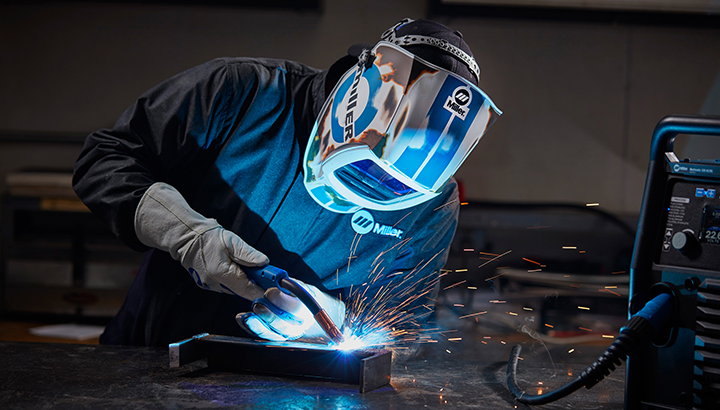 Welder wearing ventilated welding helmet PPE safety industrial