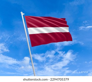Flag of Latvia waving against blue sky, photography