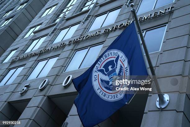 Seal of the U.S. Immigration and Customs Enforcement agency on a glass building facade, professional photography, high resolution