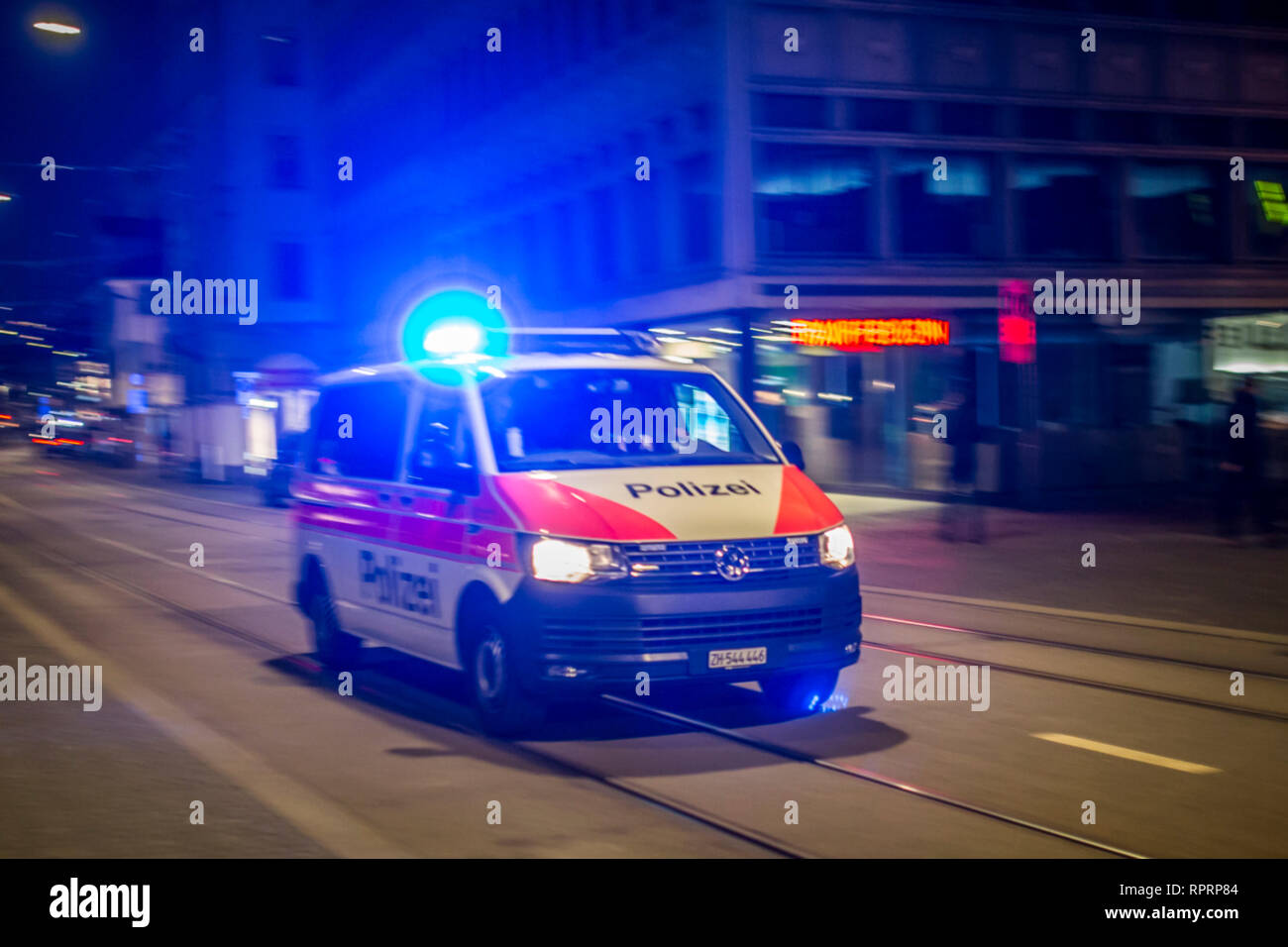Swiss police and emergency blue lights in snow night